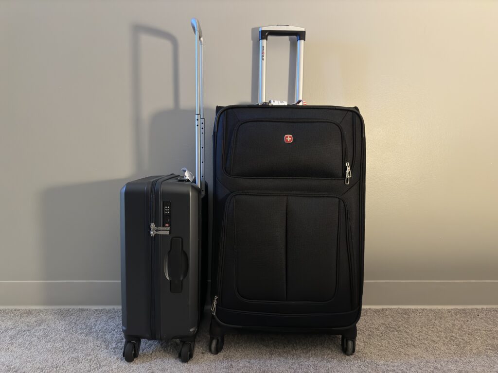 Carry on suitcase next to a SwissGear suitcase, the best budget suitcase